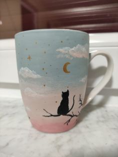 a coffee cup with a cat sitting on a tree branch