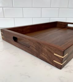 a wooden tray sitting on top of a white counter