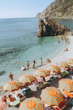 an instagram photo with people on the beach and umbrellas in the sand,