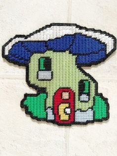 an embroidered patch with the shape of a cartoon character on it's face and eyes