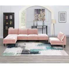 a living room with a pink couch and rug