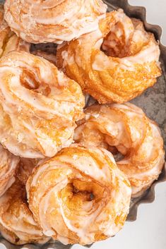 a bunch of doughnuts that are sitting in a bowl on a table top