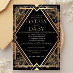 a black and gold wedding card with an art deco design on the front, surrounded by flowers