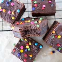 brownies with chocolate frosting and sprinkles on a cooling rack