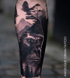 a man's leg with a monkey and trees on it