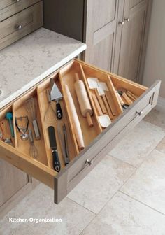 an open drawer with utensils in it