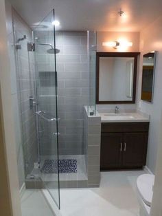 a bathroom with a shower, toilet and sink