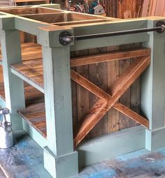 a kitchen island made out of wood and metal