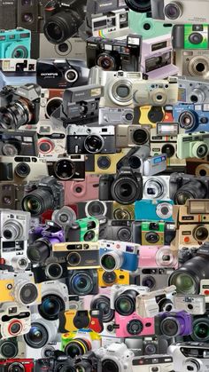 many different types of cameras stacked on top of each other with the same color and size