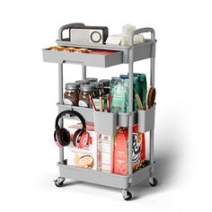 a gray trolley with food and headphones on it's wheels is shown in front of a white background