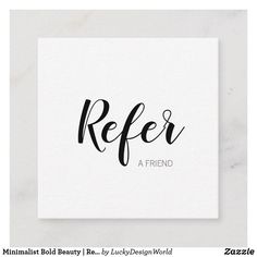 refer card with the word refer in black ink on a white marble surface, next to a