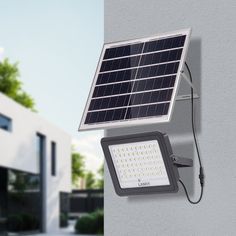 a solar powered light mounted on the side of a building