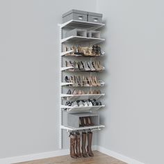 a shoe rack with several pairs of shoes on it in the corner of a room