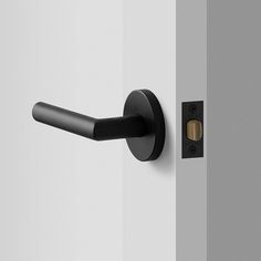 an open door with a black handle on the front and side of it, in grey tones