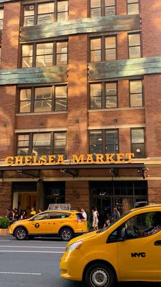 taxi cabs are parked in front of the chelsea market