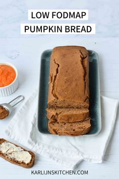 a loaf of low fodmap pumpkin bread on a plate with butter and carrots