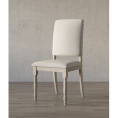 a white chair sitting on top of a hard wood floor next to a gray wall