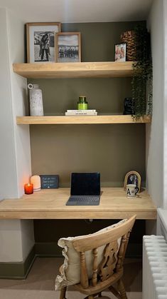 a wooden desk with a laptop on top of it next to a radiator