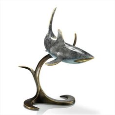 a statue of a shark on a metal stand