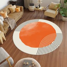 an aerial view of a living room with orange and white rugs on the floor