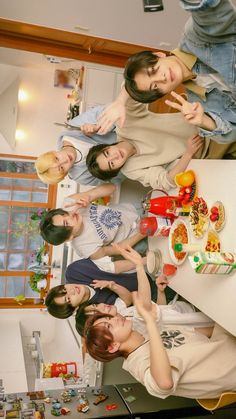 a group of young women standing around a kitchen counter with food on top of it