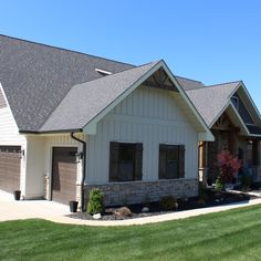 a large house with two garages on the front and one attached to the side