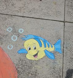 a drawing of a fish on the sidewalk