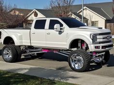 a white truck parked in front of a house