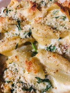 a close up of some food on a plate with broccoli and cheese in it