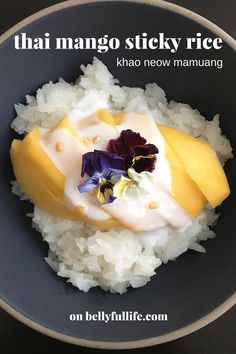 there is rice and mango on the plate with some flowers in it that says, thai mango sticky rice khao neow mammang