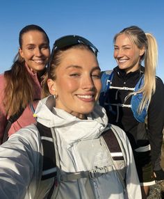 three women taking a selfie on top of a mountain