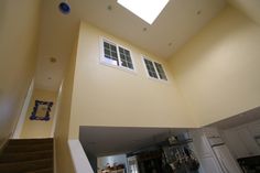 an overhead view of a staircase leading up to a kitchen and living room with skylights