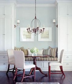 a dinning room table with chairs and a bench in front of the dining area