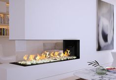 a modern fireplace in a living room with white walls