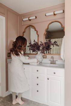 Mauve And White Bathroom, Brushed Brass Vanity Mirror, Master Bath Remodel On A Budget, Maryland Townhouse, Builder Grade Bathroom Makeover, Mauve Paint, Gold Light Fixtures, Builder Grade Bathroom