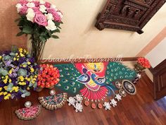 colorful flowers and jewelry are on the floor in front of a decorative sign that reads, thanks ramamatra