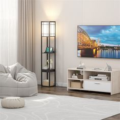 a living room with a large television and white furniture