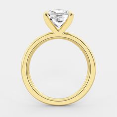 a yellow gold engagement ring with a princess cut diamond in the center, on a white background