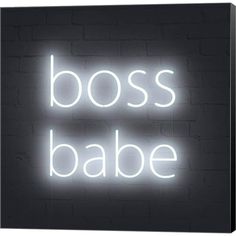 a neon sign that says boss babe in white letters on a black brick wall background