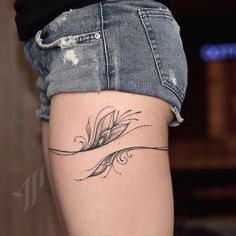 a woman's thigh with a tattoo design on the lower part of her leg