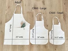 two aprons with measurements for each child's size are shown on the floor