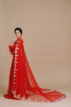 This stunning Vietnamese wedding ao dai is made for the queen in you. Take your traditional Vietnamese dress to the next level with a beautiful (and removable!) red bridal cape embroidered with light gold lace applique. Walk that wedding runway and impress your relatives and loved ones with this show-stopping design that pays homage to your heritage. Be prepared for gorgeous wedding photos. Groom's outfit recommendation: Pair this with our Nguyen or Hong Jacket. Accessory recommendation: Pair th Modern Vietnamese Wedding, Traditional Vietnamese Dress, Vietnamese Wedding Ao Dai, Wedding Ao Dai, Vietnamese Wedding Dress, Tea Ceremony Dress, Wedding Qipao, Vietnamese Wedding, Ceremony Dress