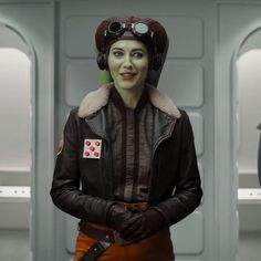 a woman in a star wars costume with goggles on her head and gloves around her waist