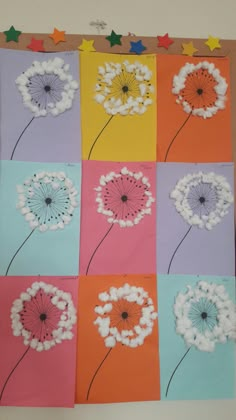 an art project with paper flowers and stars on the wall above it is a photo of dandelions in different colors