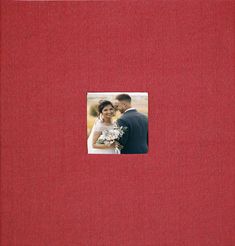 a red photo album with a couple in it