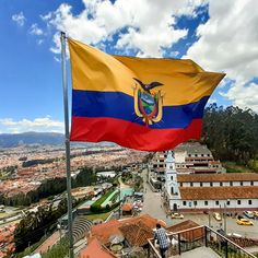 a flag flying in the wind on top of a building