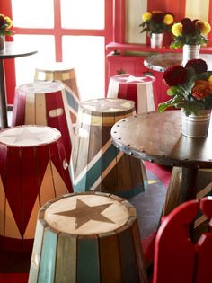 colorfully painted stools and tables in a brightly colored room with flowers on them