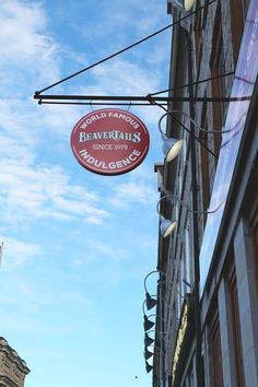 a sign hanging from the side of a building that says beavertails since 1909 on it