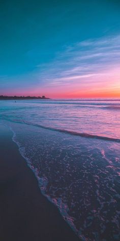 the sun is setting over the water at the beach