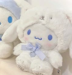 two white stuffed animals sitting next to each other